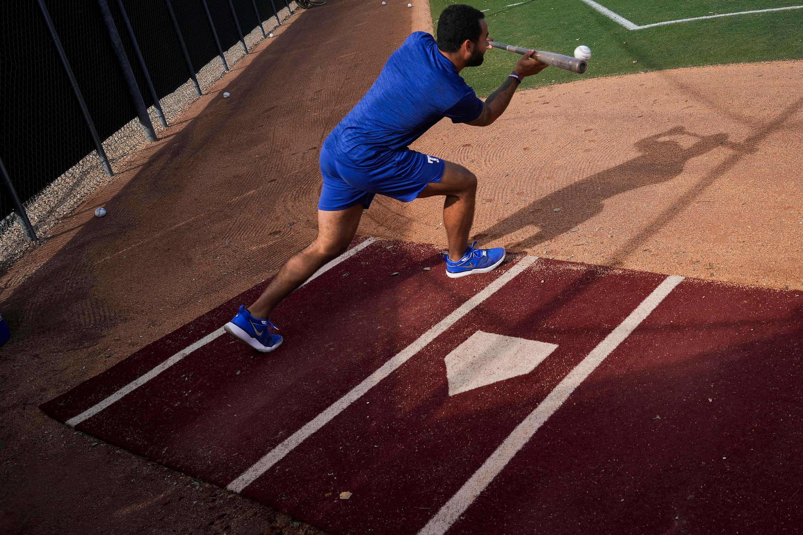 Texas Rangers outfielder Derek Hill participates in a bunting drill during a spring training...