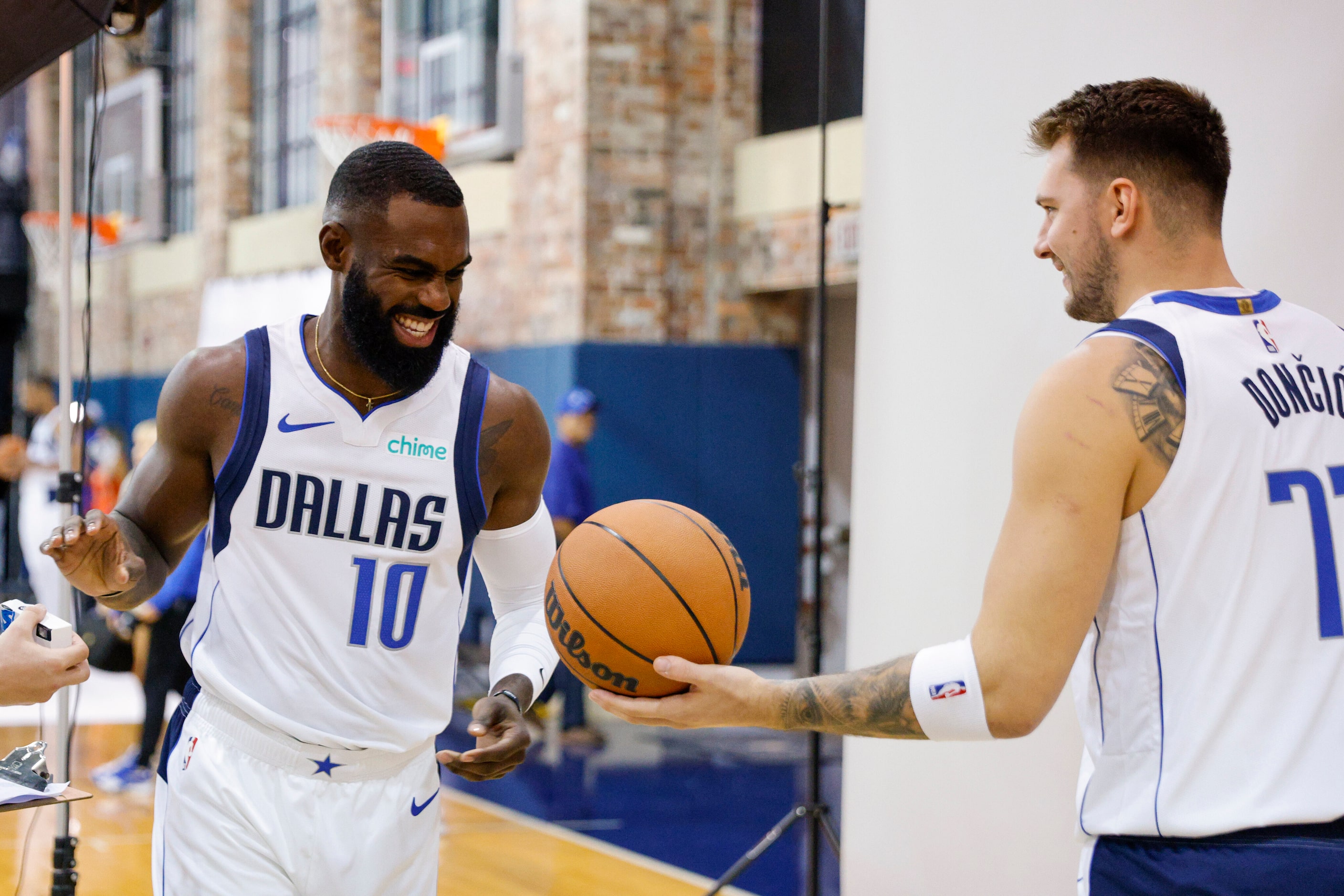 Dallas Mavericks forward Tim Hardaway Jr. (10) laughs with guard Luka Doncic (77) during...