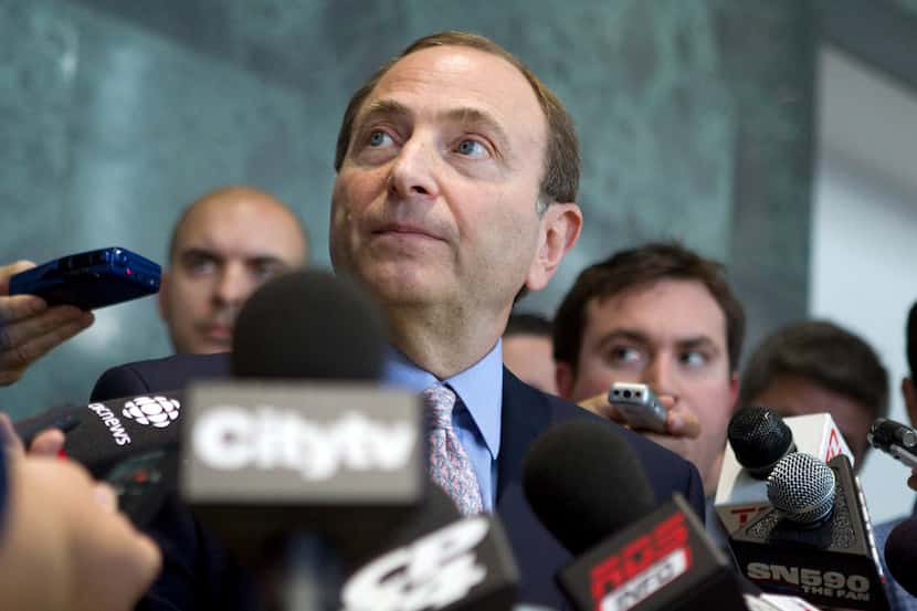 NHL commissioner Gary Bettman talks with reporters after NHL labor talks in Toronto,...