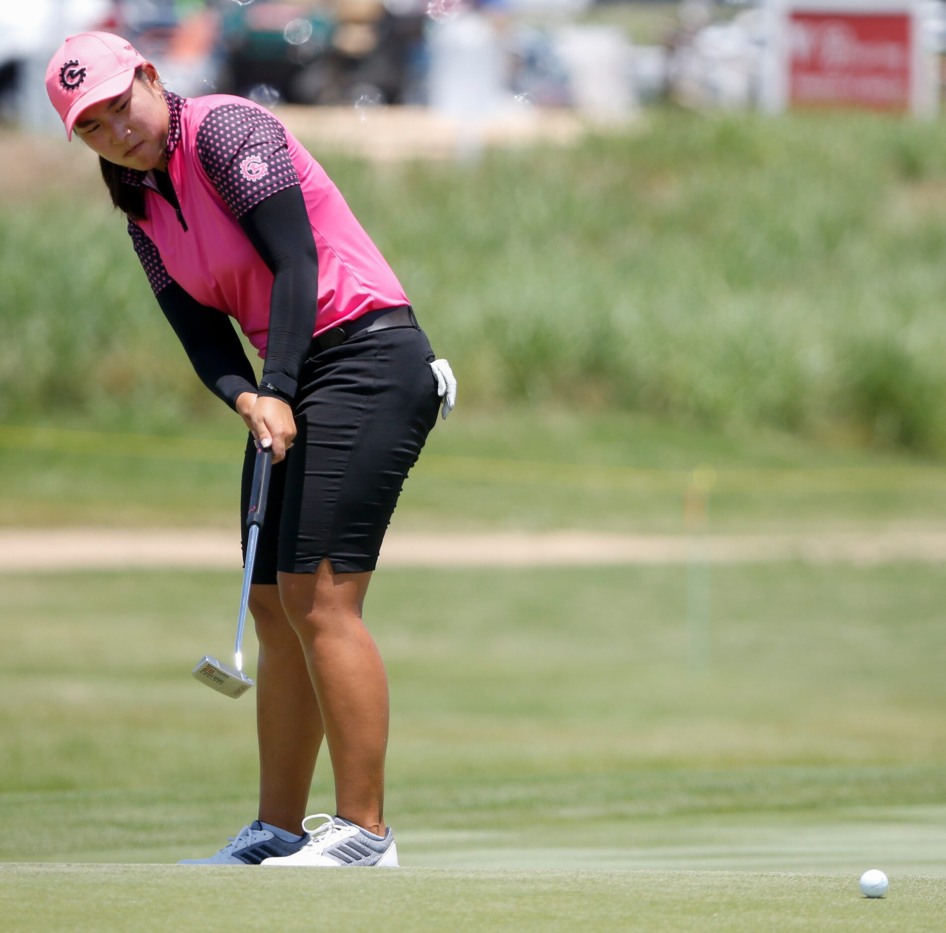 Professional golfer Min-G Kim watches her putt on the 18th green during round one of the...