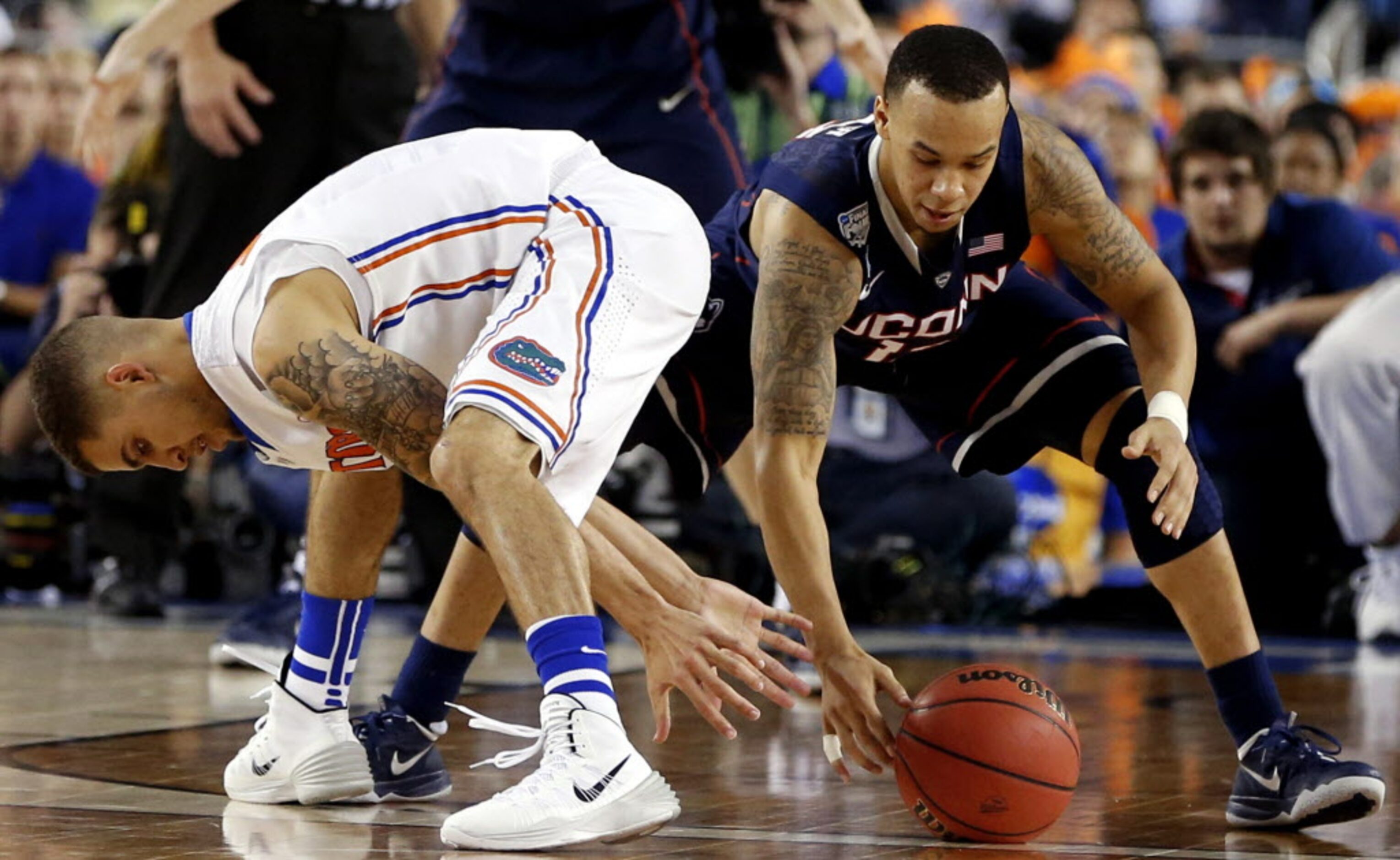 Florida Gators guard Scottie Wilbekin (left) and Connecticut Huskies guard Shabazz Napier...