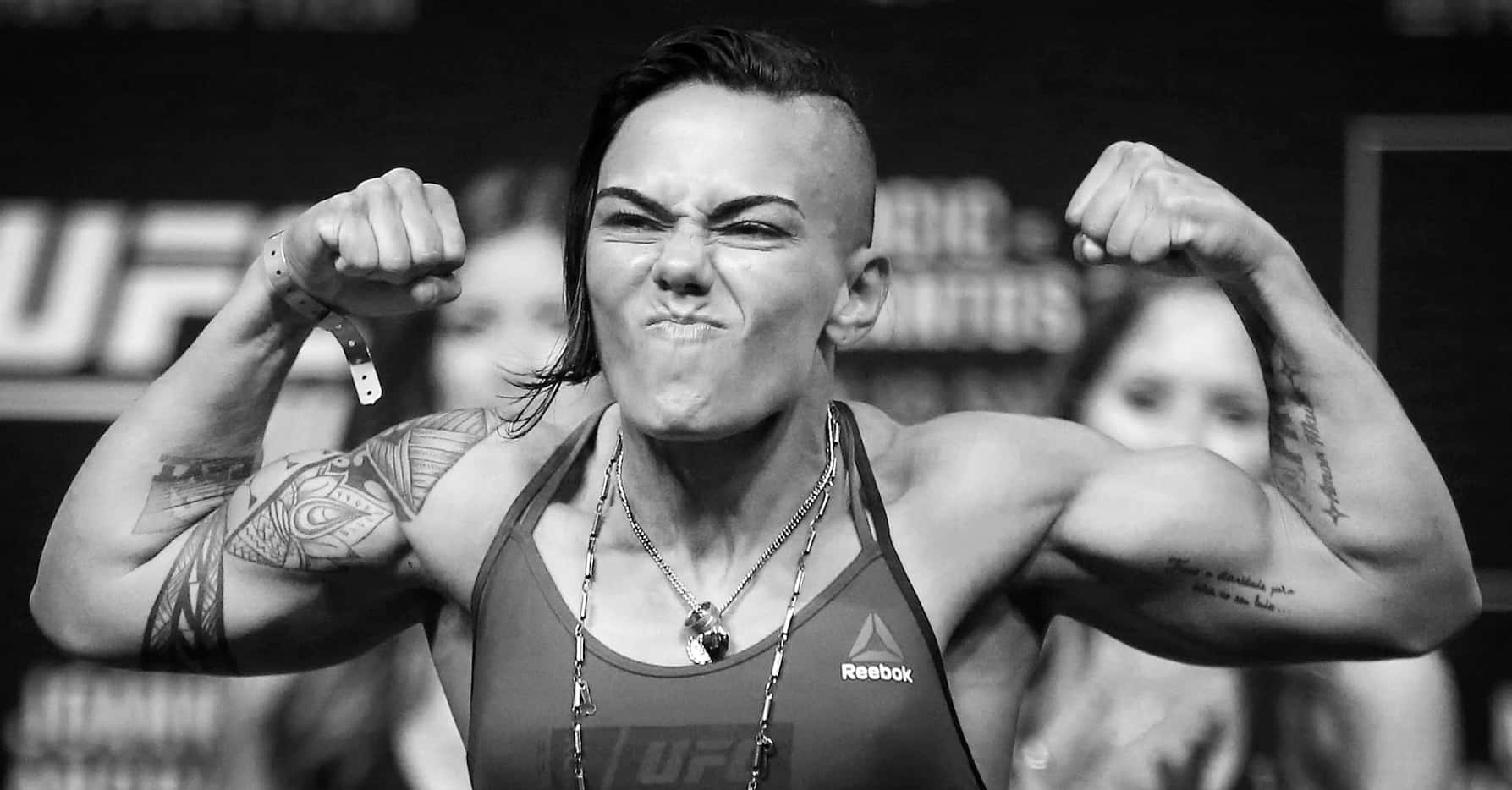 Women's Strawweight fighter Jessica Andrade strikes a pose on the scale as she weighs-in for...