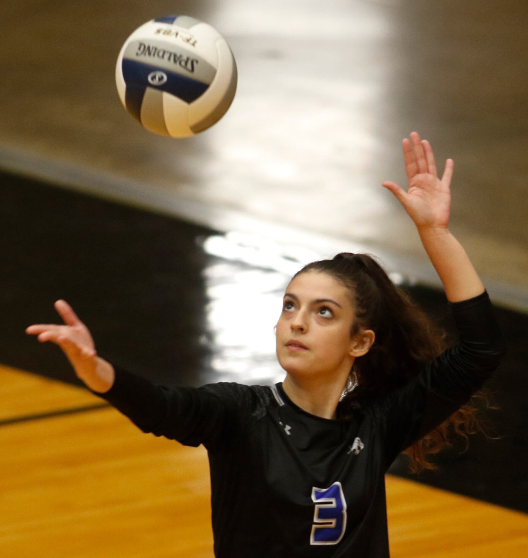 Trophy Club Byron Nelson's Gia Santini (3) focuses as she serves during the 2nd game of...