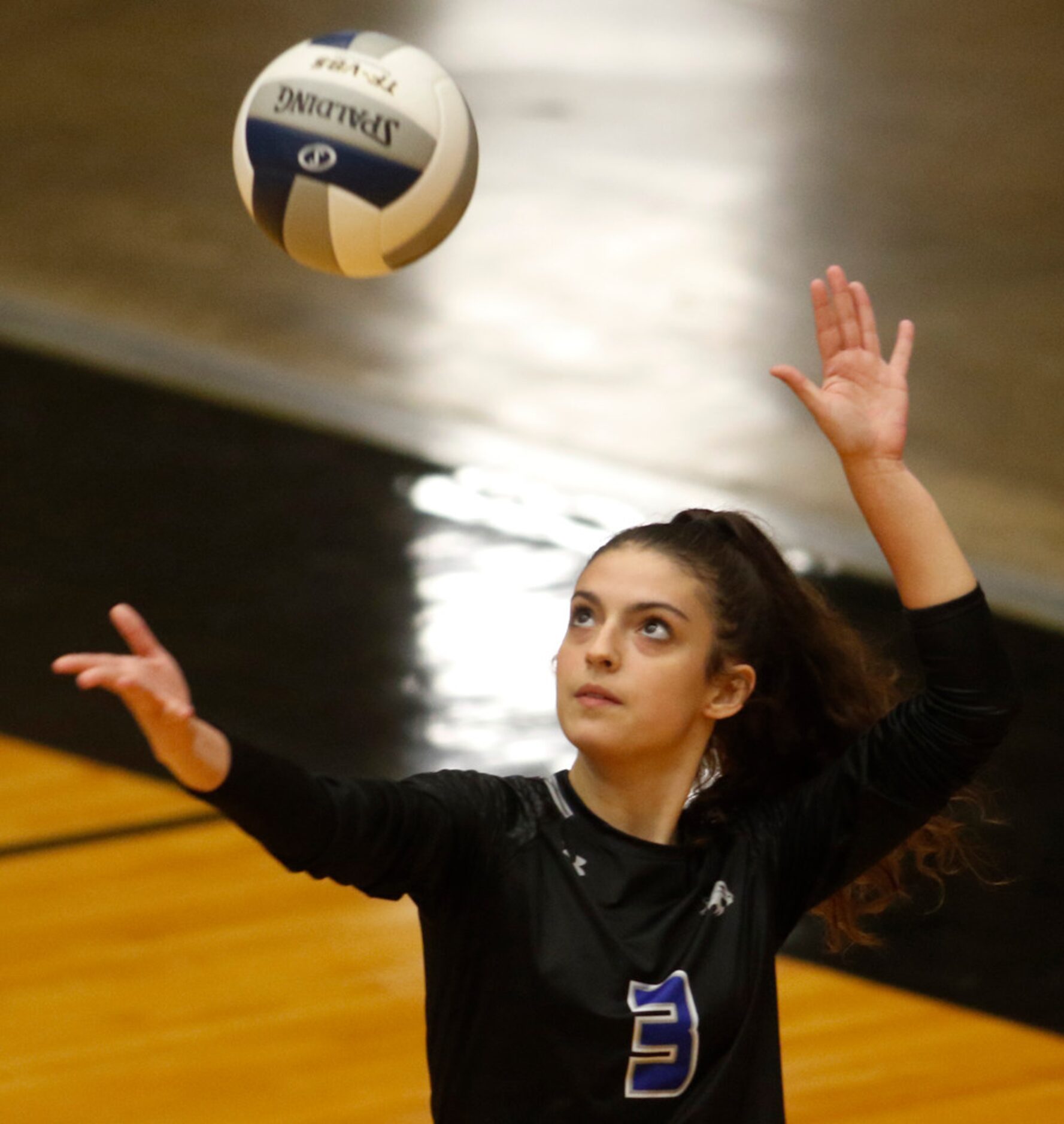 Trophy Club Byron Nelson's Gia Santini (3) focuses as she serves during the 2nd game of...