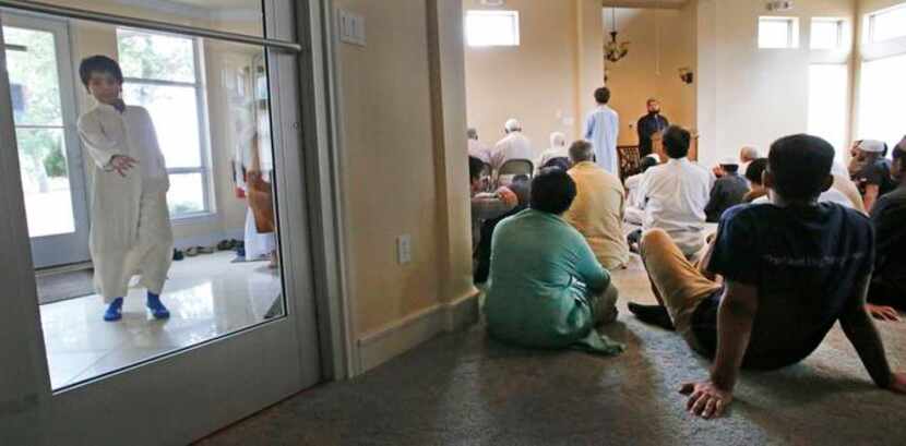
A Muslim boy made his way into a gathering for teaching and prayers at the Islamic...