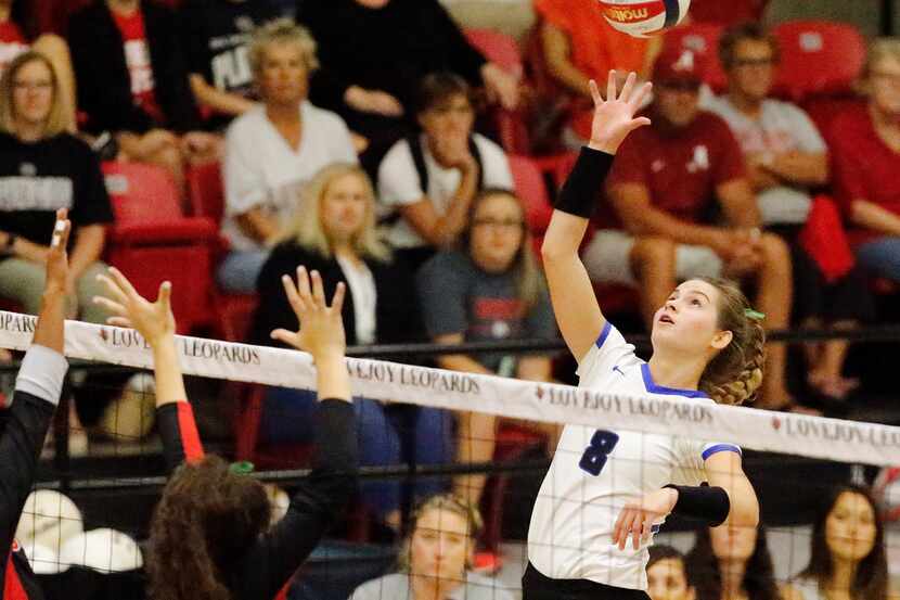 Trophy Club Byron Nelson outside hitter Paige Flickinger (8) tips the ball over the net...