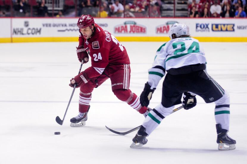 Apr 13, 2014; Glendale, AZ, USA; Phoenix Coyotes center Kyle Chipchura (24) carries the puck...