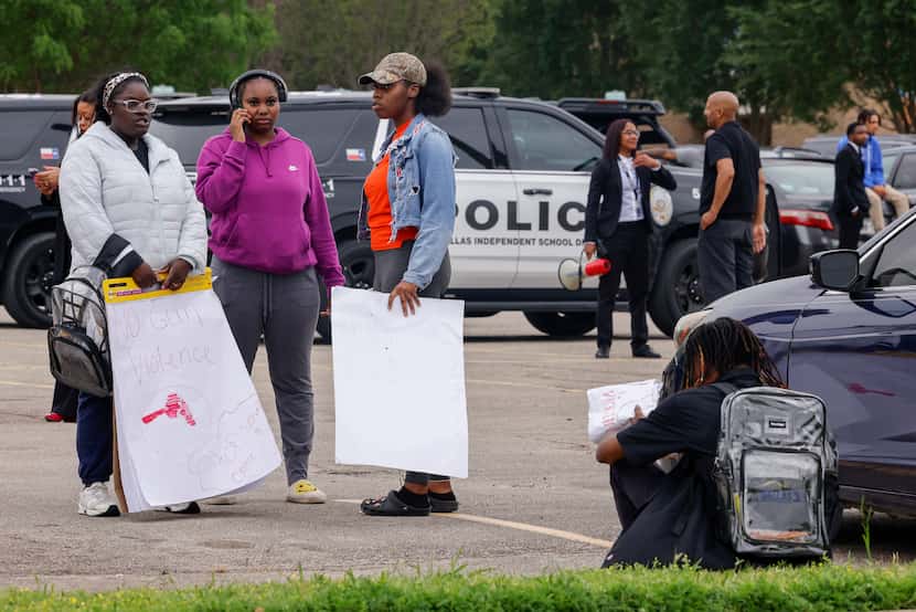 Students hold signs during a protest outside Wilmer-Hutchins High School, Monday, April 15,...