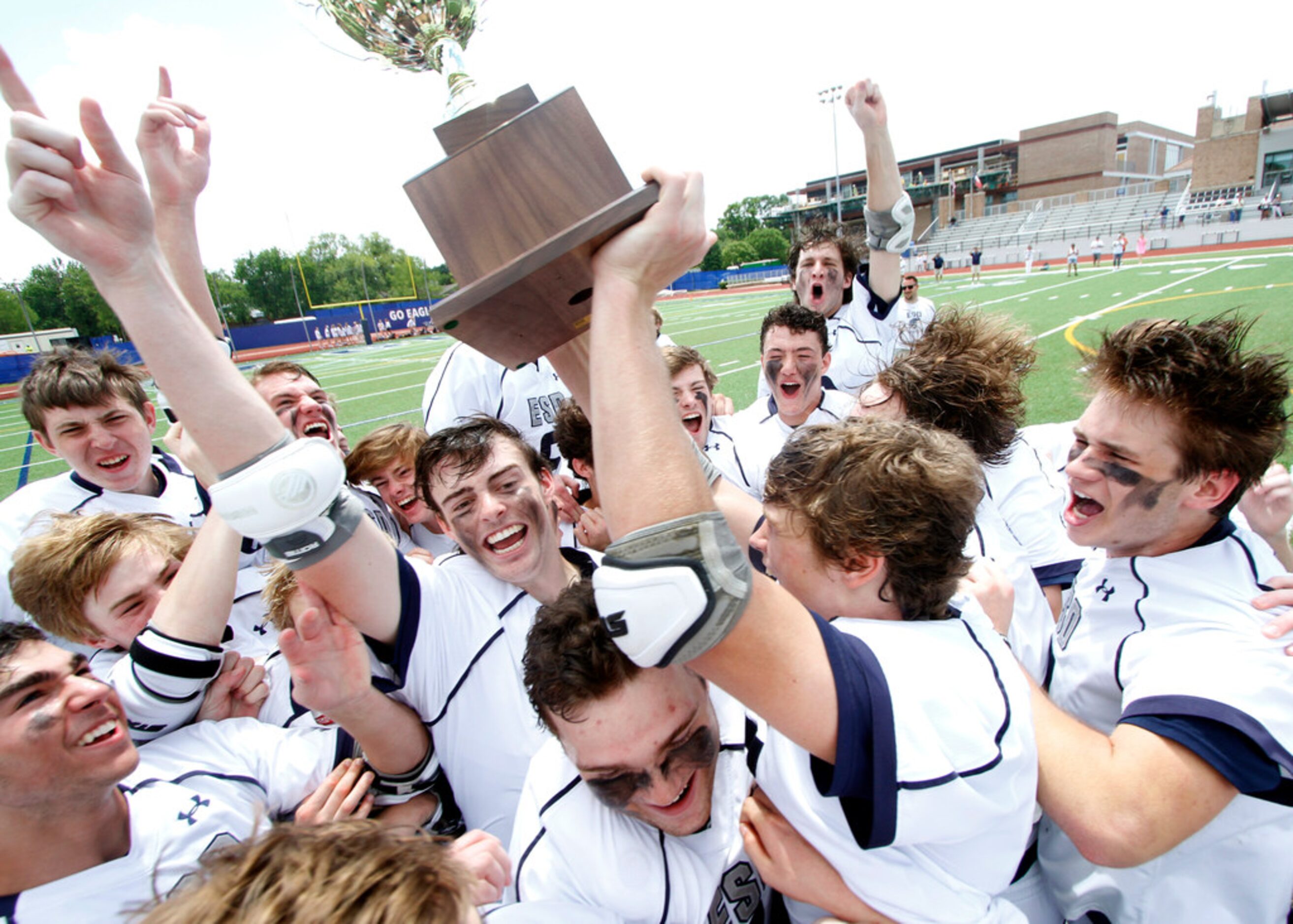 Members of the Episcopal School of Dallas lacrosse team break out in euphoria after being...