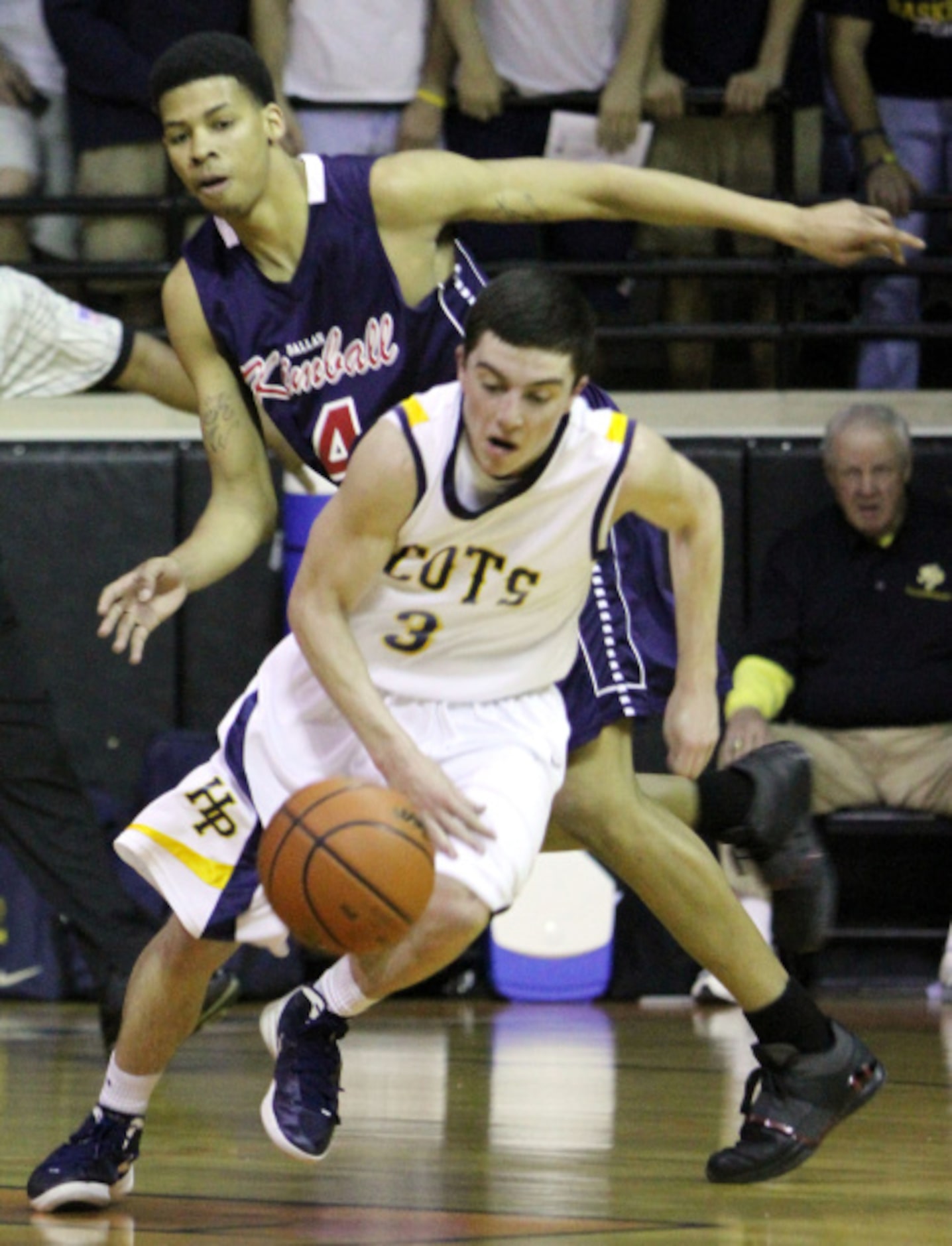 McKinney High School's A.J. Moutry (4) drives to the basket for two points against Wylie...