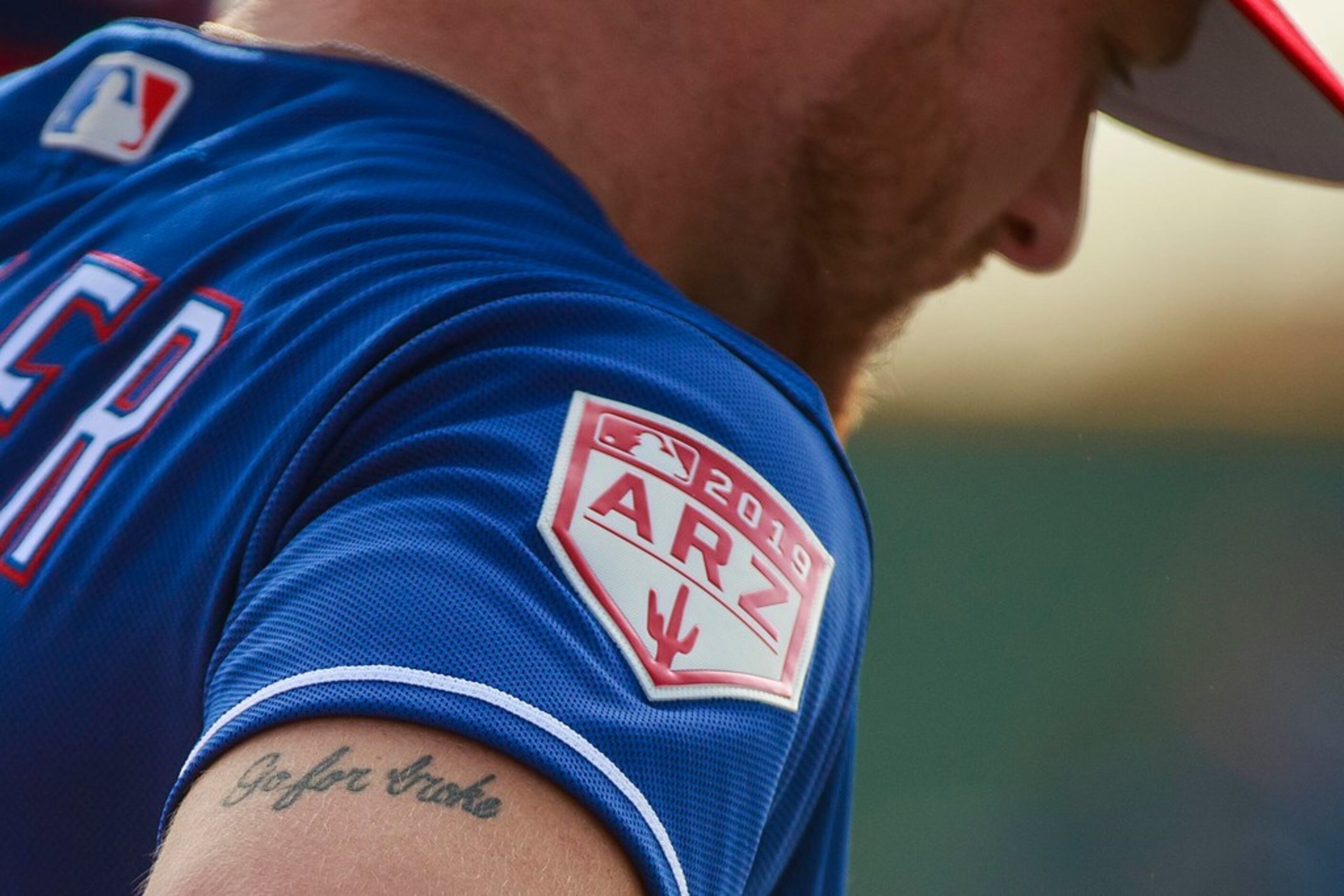 The tattoo on the right arm of Texas Rangers pitcher Shelby Miller reads "Go For Broke" as...