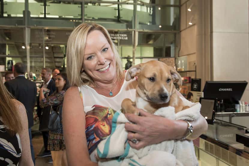 Kristen Greenberg held an adoptable pup from the SPCA of Texas.