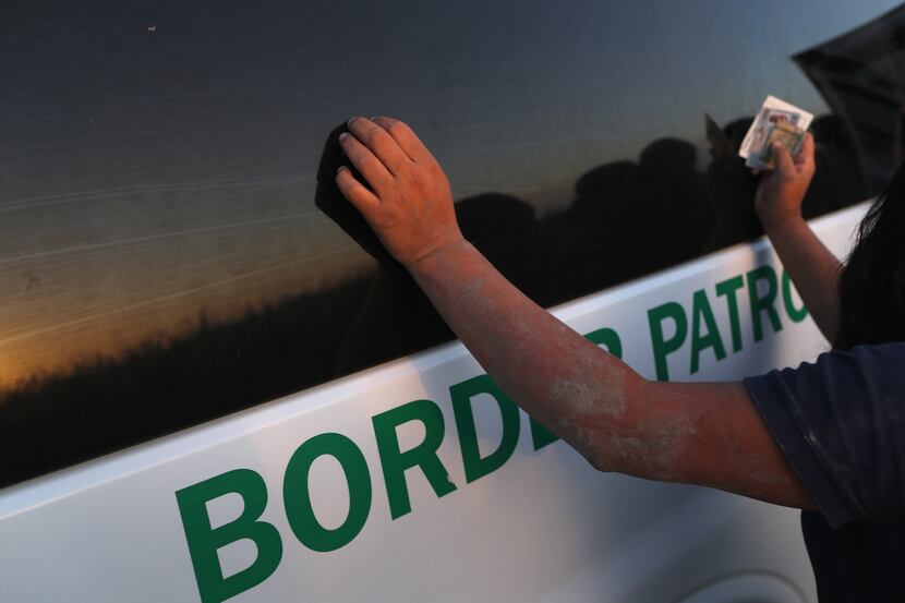An immigrant is body-searched by a U.S. Border Patrol agent.