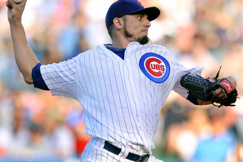 Chicago Cubs starter Matt Garza delivers a pitch during the first inning of a baseball game...