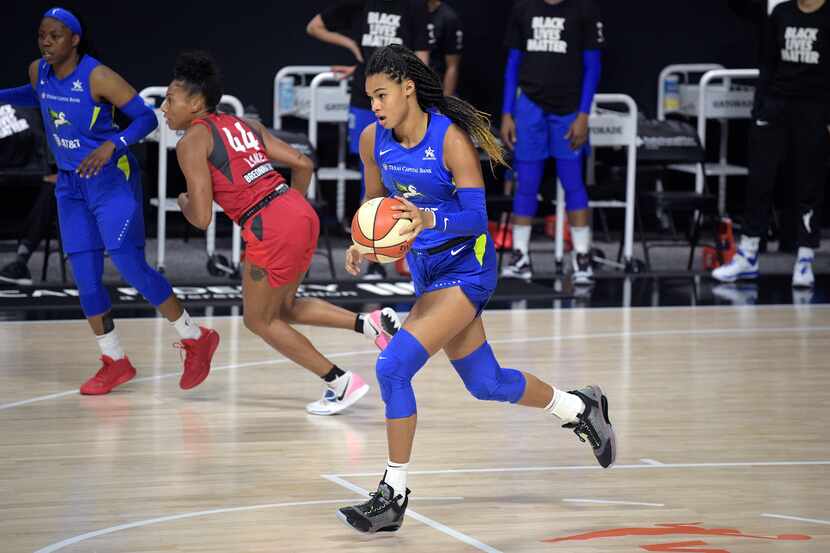 Dallas Wings forward Satou Sabally pushes the ball up the court during the second half of a...