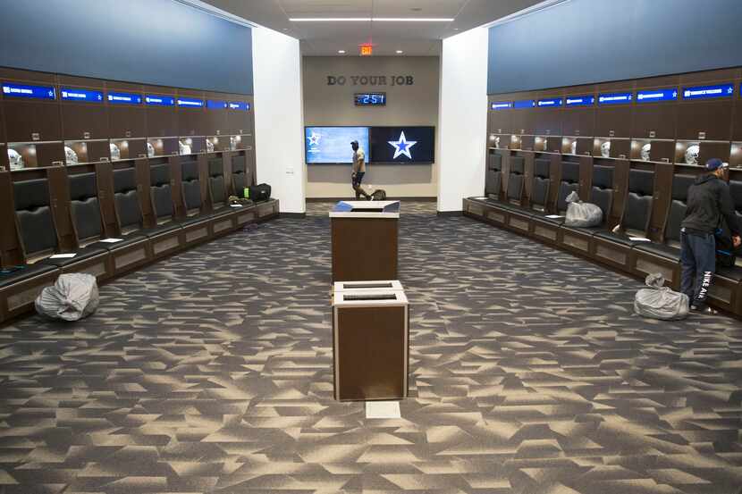 Dallas Cowboys safety Darian Thompson, right, at his locker at Ford Center at the Star in...