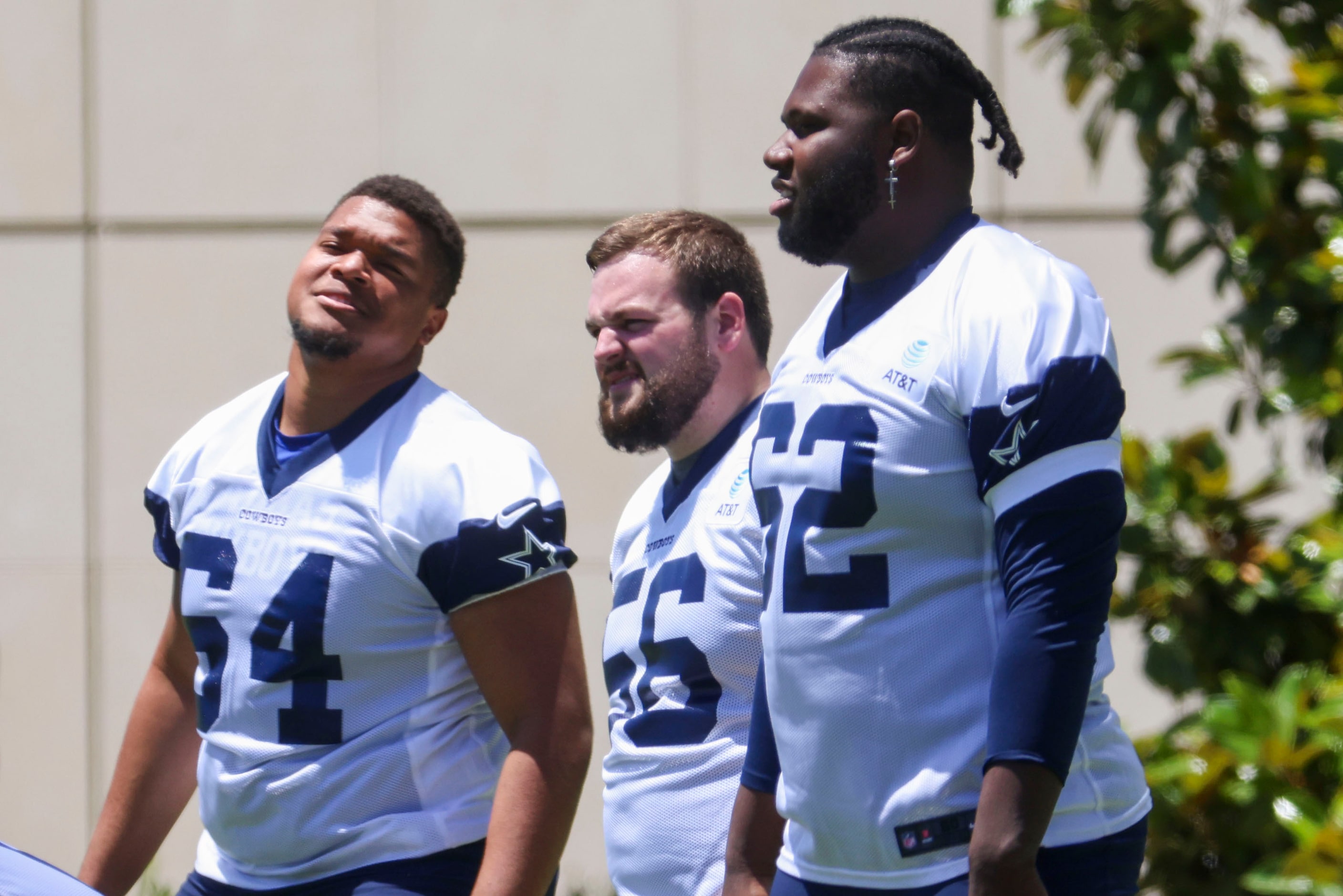 Dallas Cowboys offensive line Earl Bostick (64), Cooper Beebe (56), and Nathan Thomas (62)...