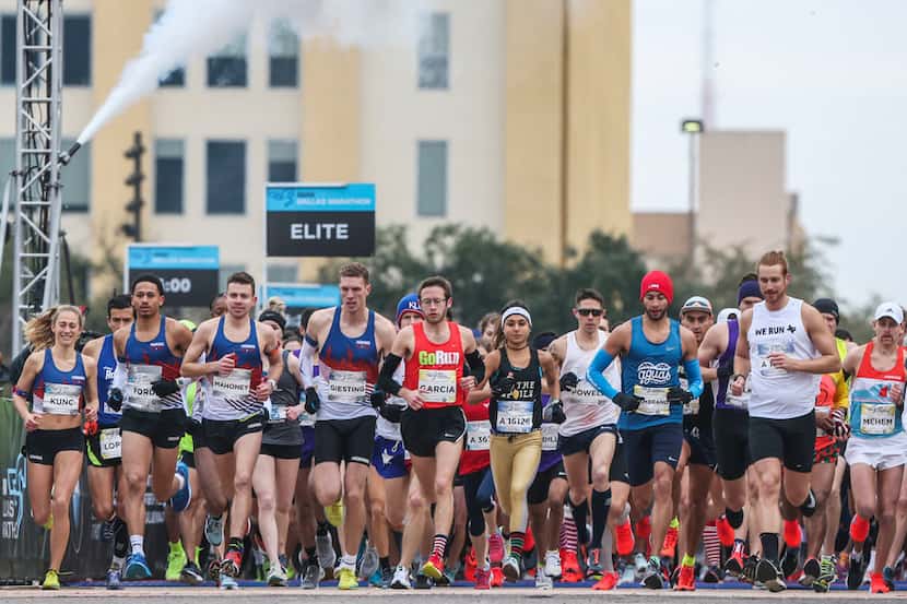 Runners take off at the start line during the BMW Dallas Marathon at Dallas City Hall Plaza...