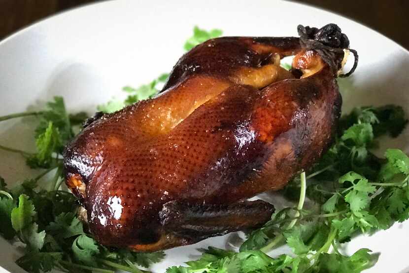 Lacquered roast duck, which makes a stunning centerpiece for a celebratory dinner, is...