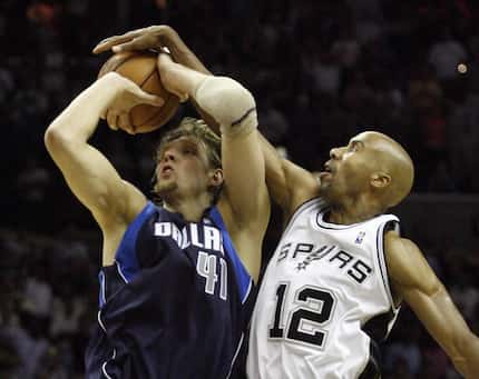 Dallas Mavericks Dirk Nowitzki is blocked by San Antonio Spurs Bruce Bowen during the second...