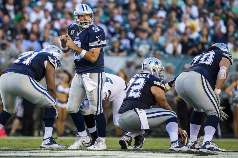 Dallas Cowboys quarterback Tony Romo (9) calls a play during the second half of their game...