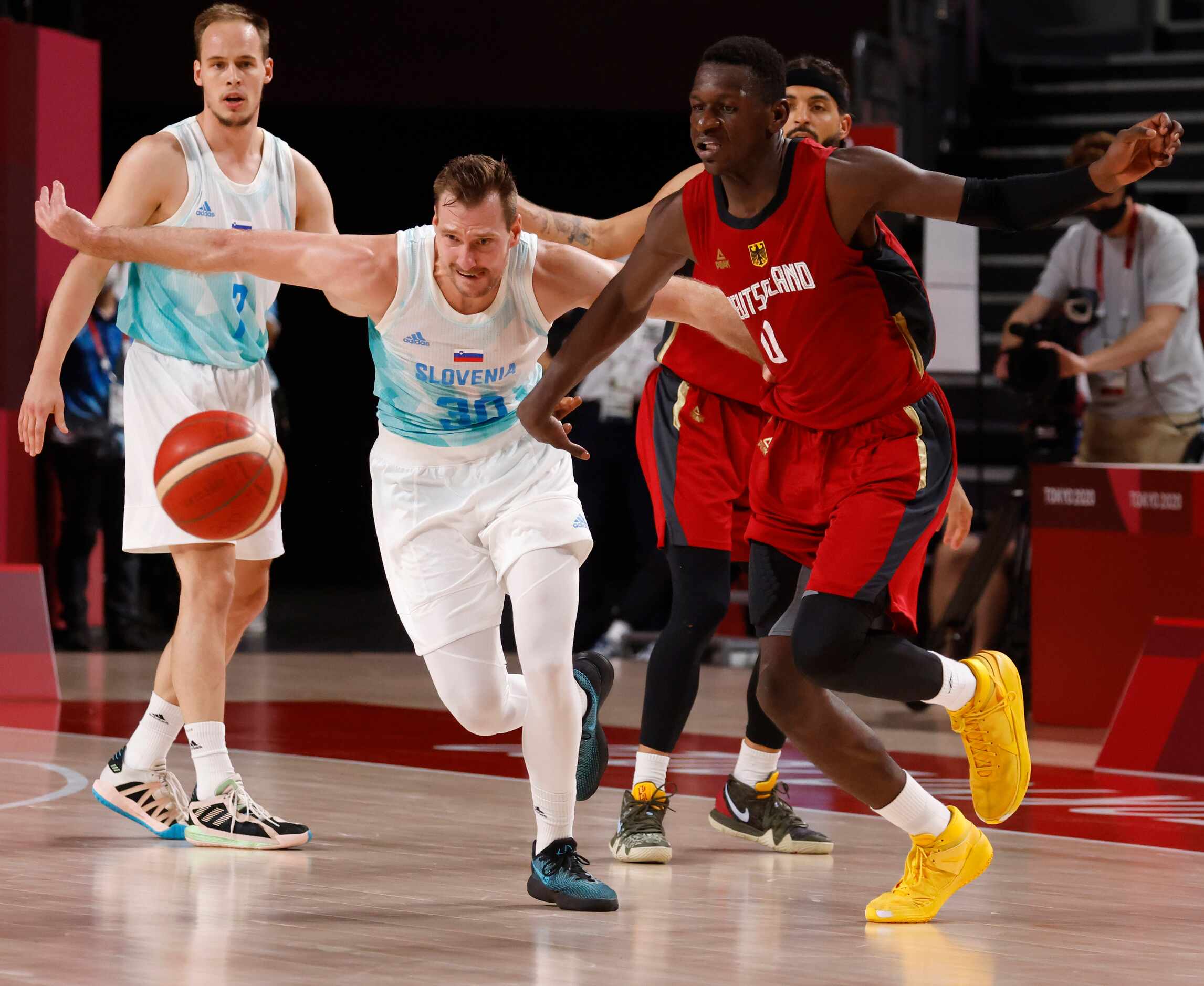 Slovenia’s Zoran Dragic (30) and Germany’s Isaac Bonga (0) go after a loose ball during the...