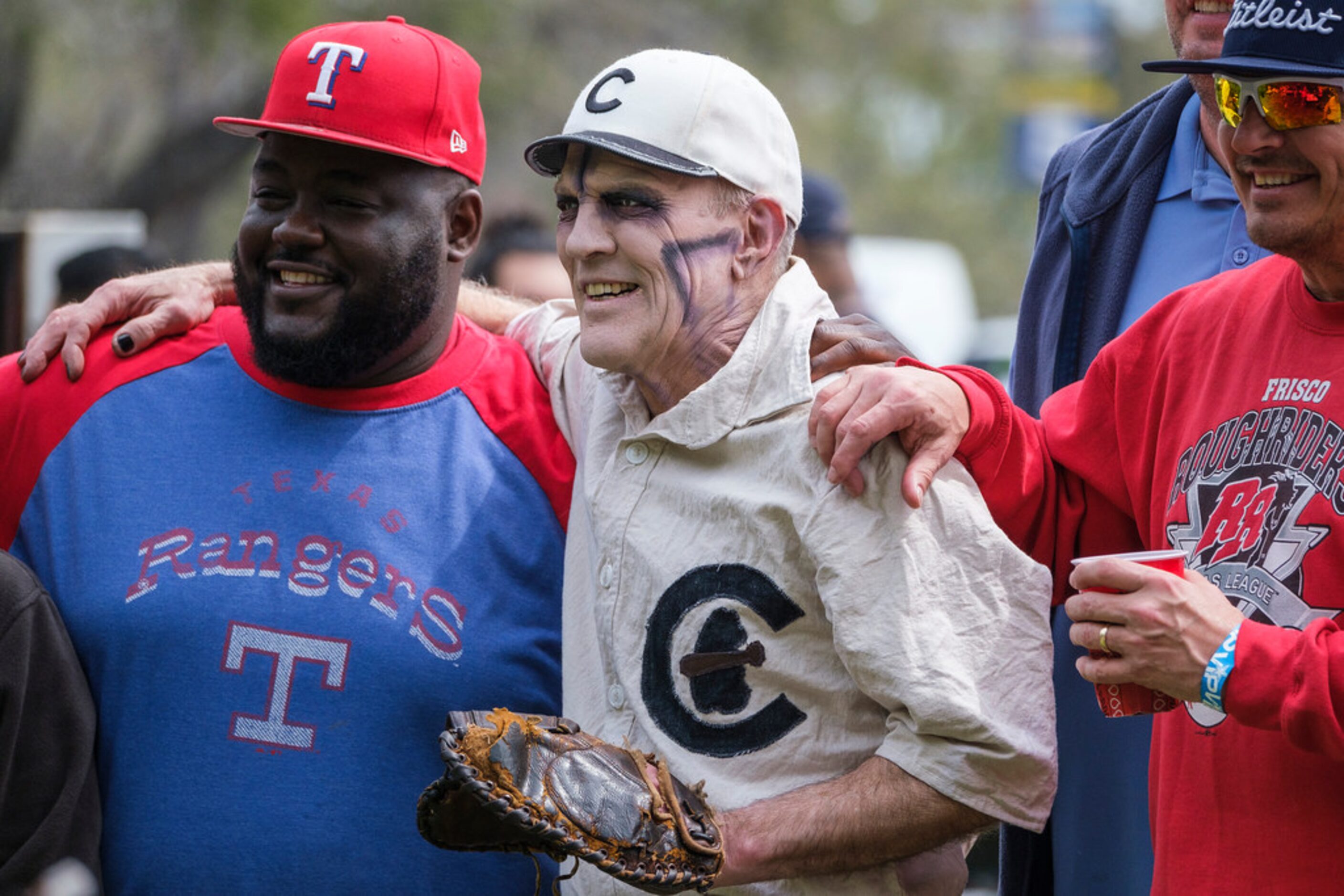 Costumed fans tailgate before the Texas Rangers opening day game against the Chicago Cubs at...