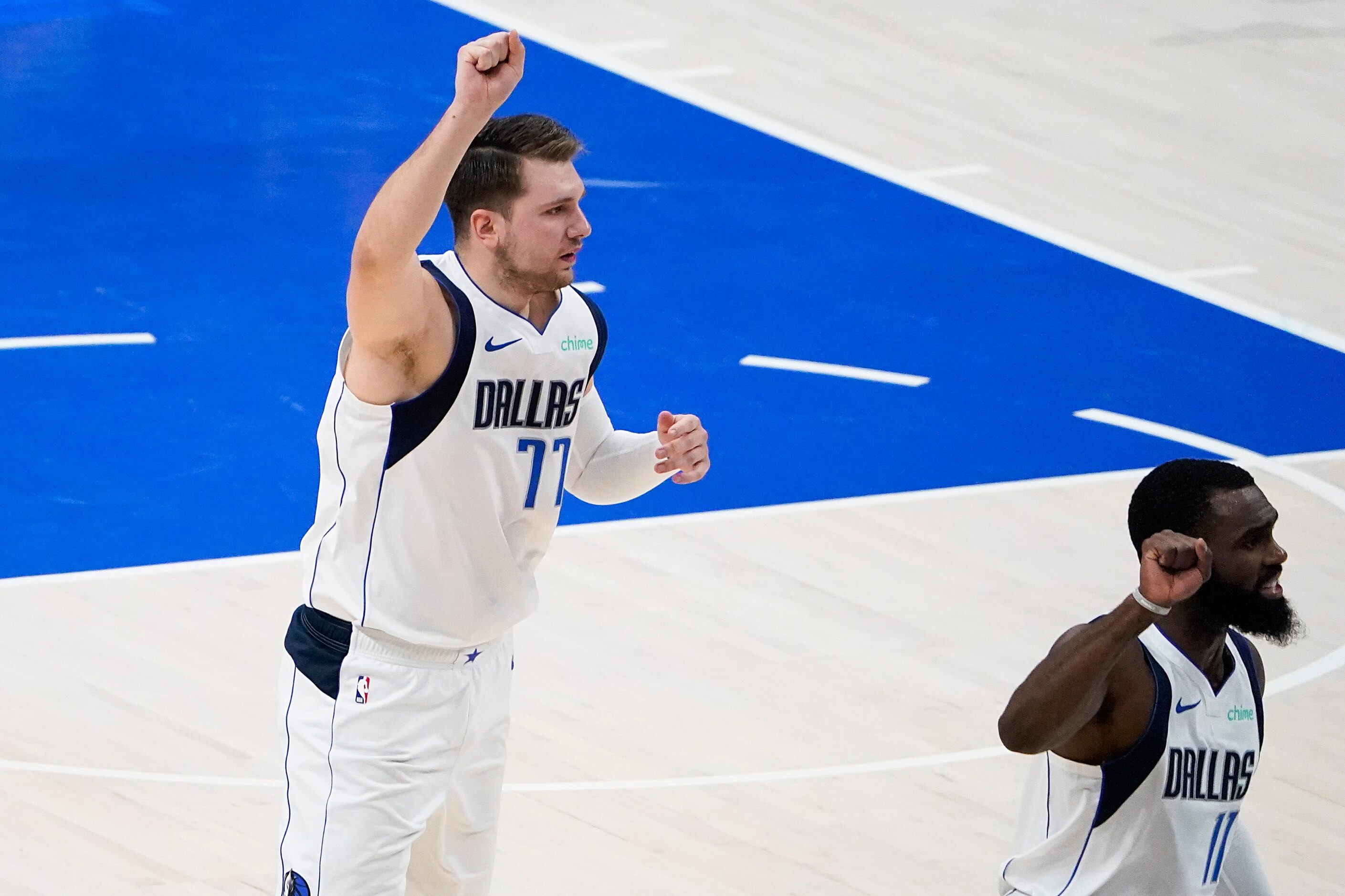 Dallas Mavericks guard Luka Doncic (77) celebrates a basket by forward Tim Hardaway Jr. (11)...