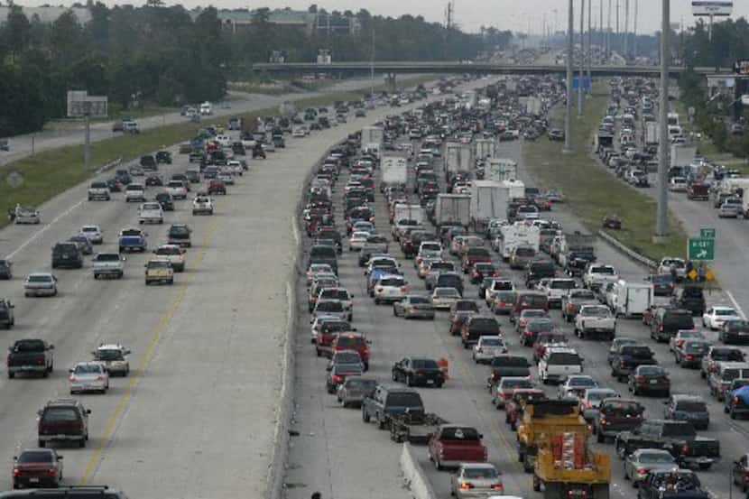 Heavy traffic flows northbound out of Houston on Interstate 45 on both sides of the highway...