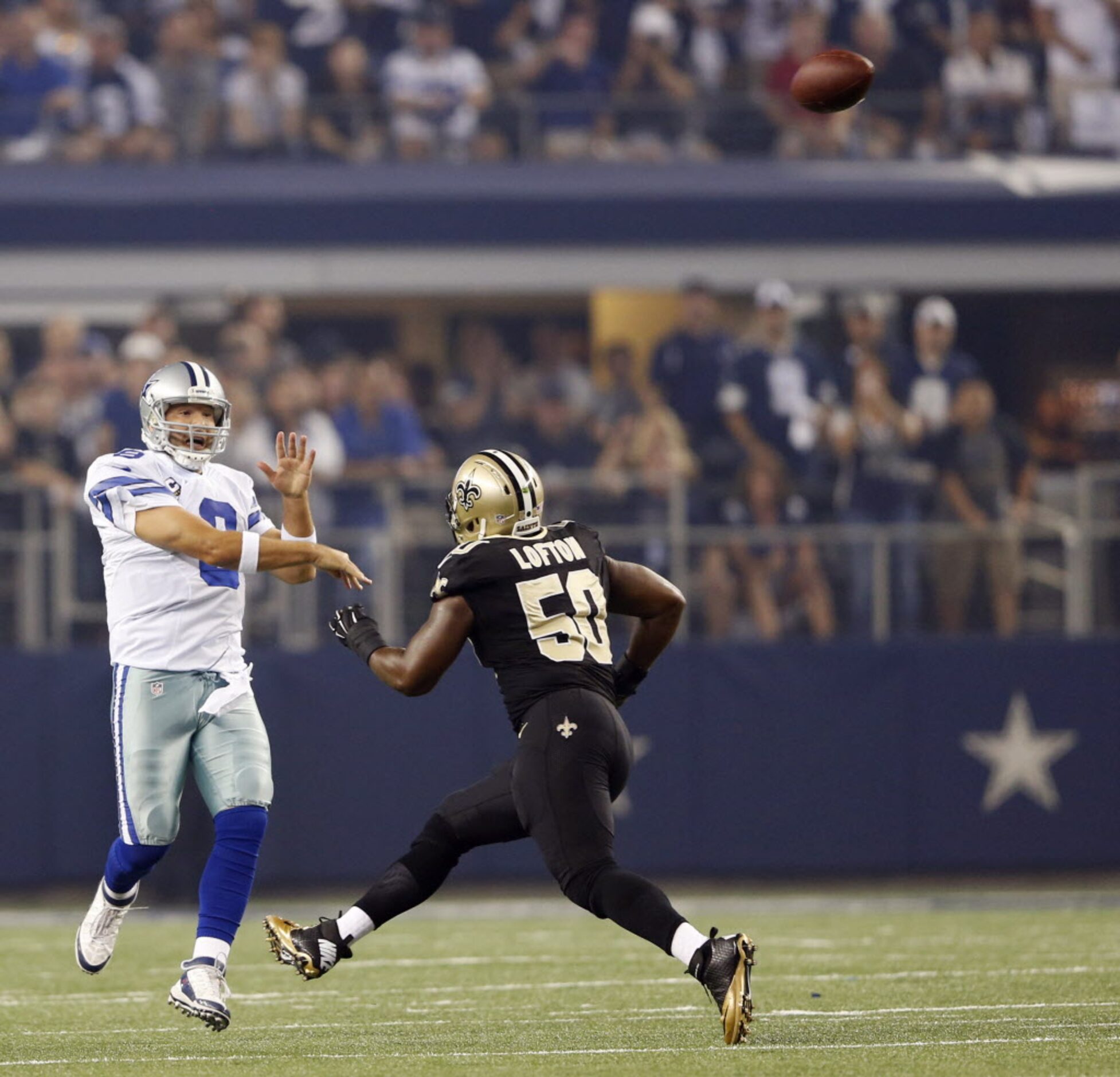 Dallas Cowboys quarterback Tony Romo (9) passes the ball as New Orleans Saints middle...