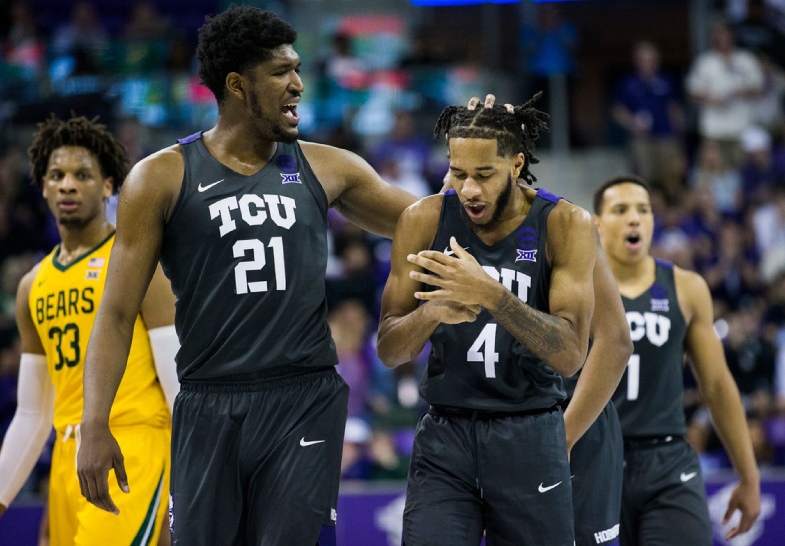 TCU Horned Frogs center Kevin Samuel (21) rubs the head of guard PJ Fuller (4) after a foul...