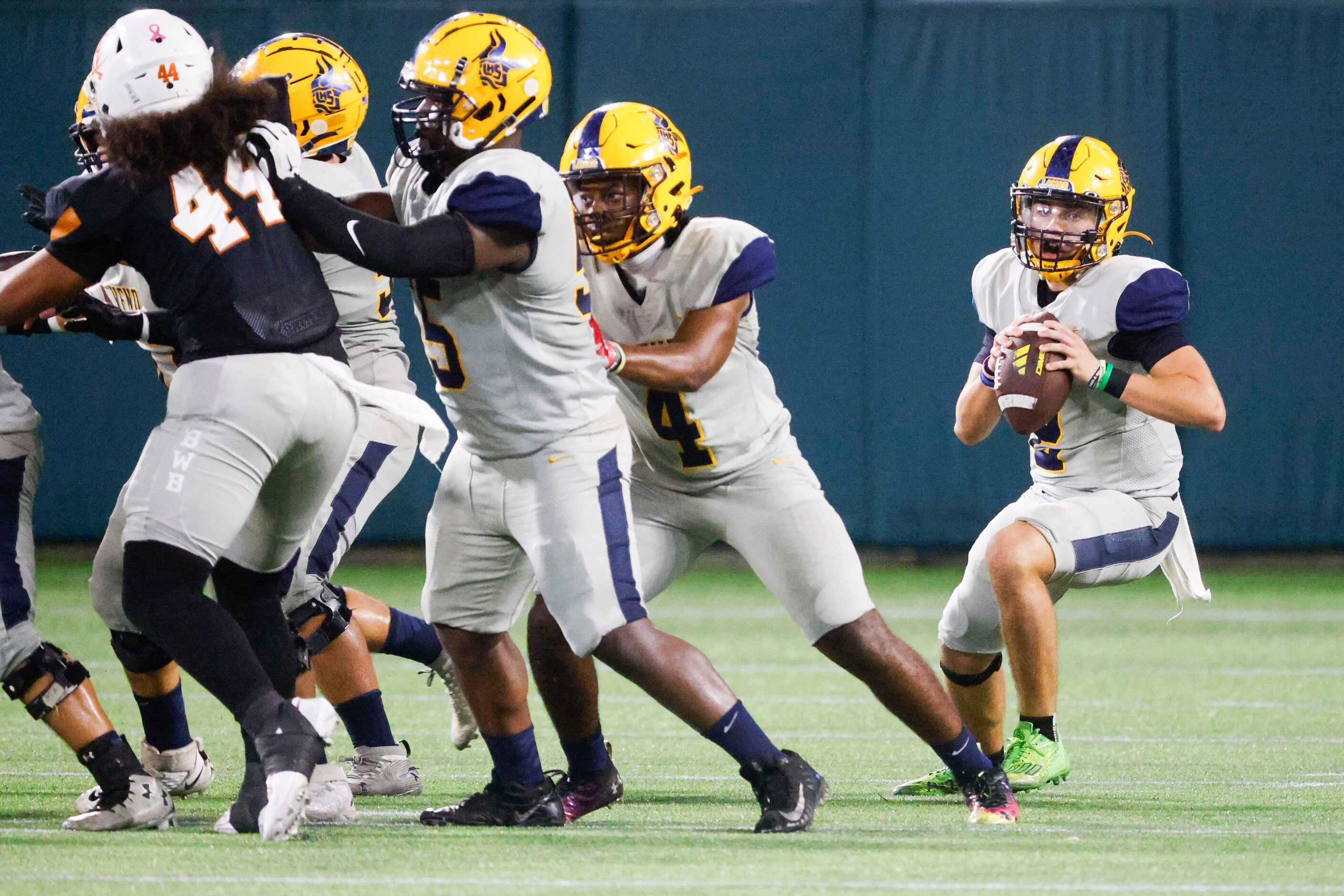 Lamar High’s QB Gannon Carey looks to throw the ball during the first half of a football...