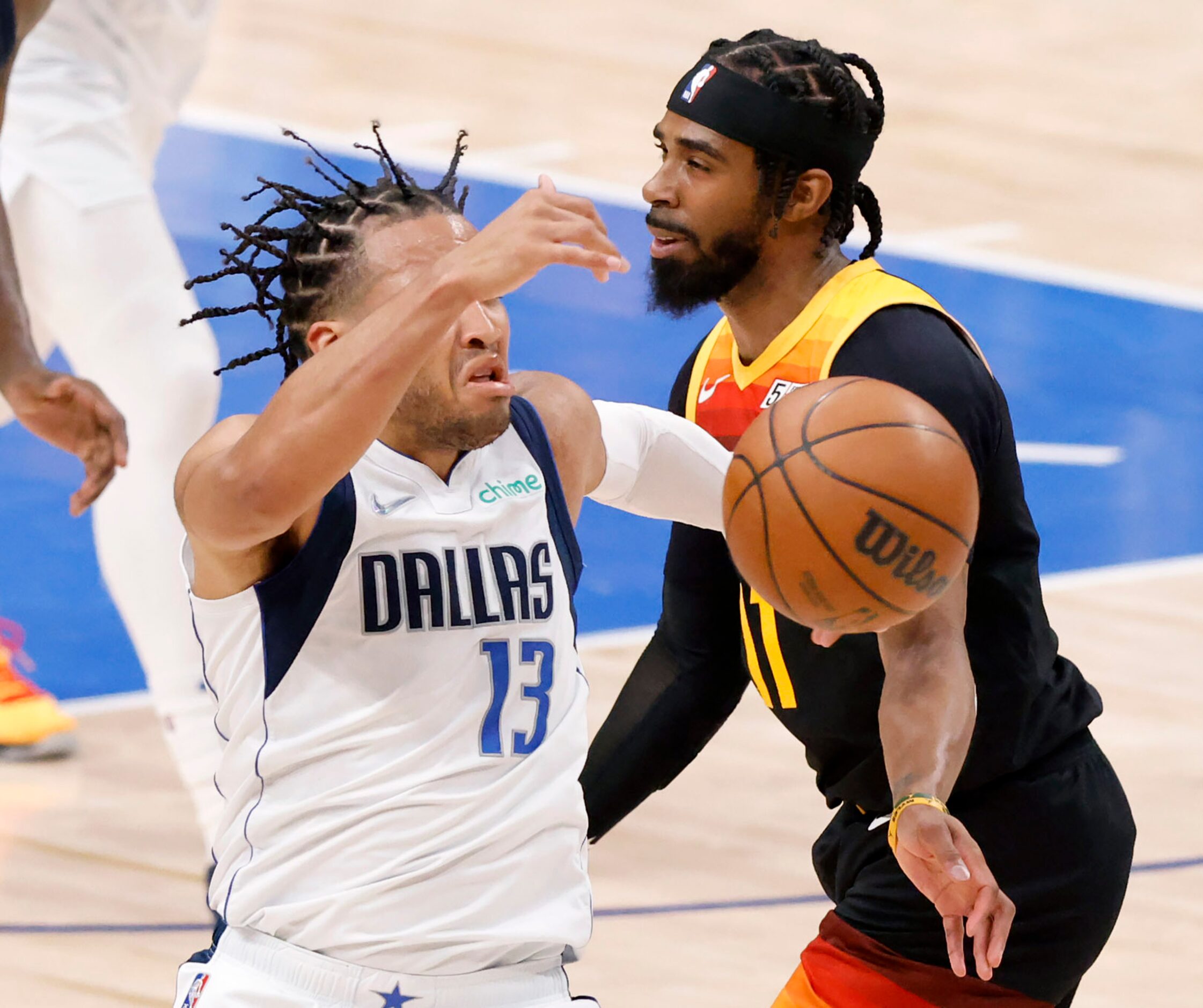 Dallas Mavericks guard Jalen Brunson (13) is fouled across the face by Utah Jazz guard Mike...