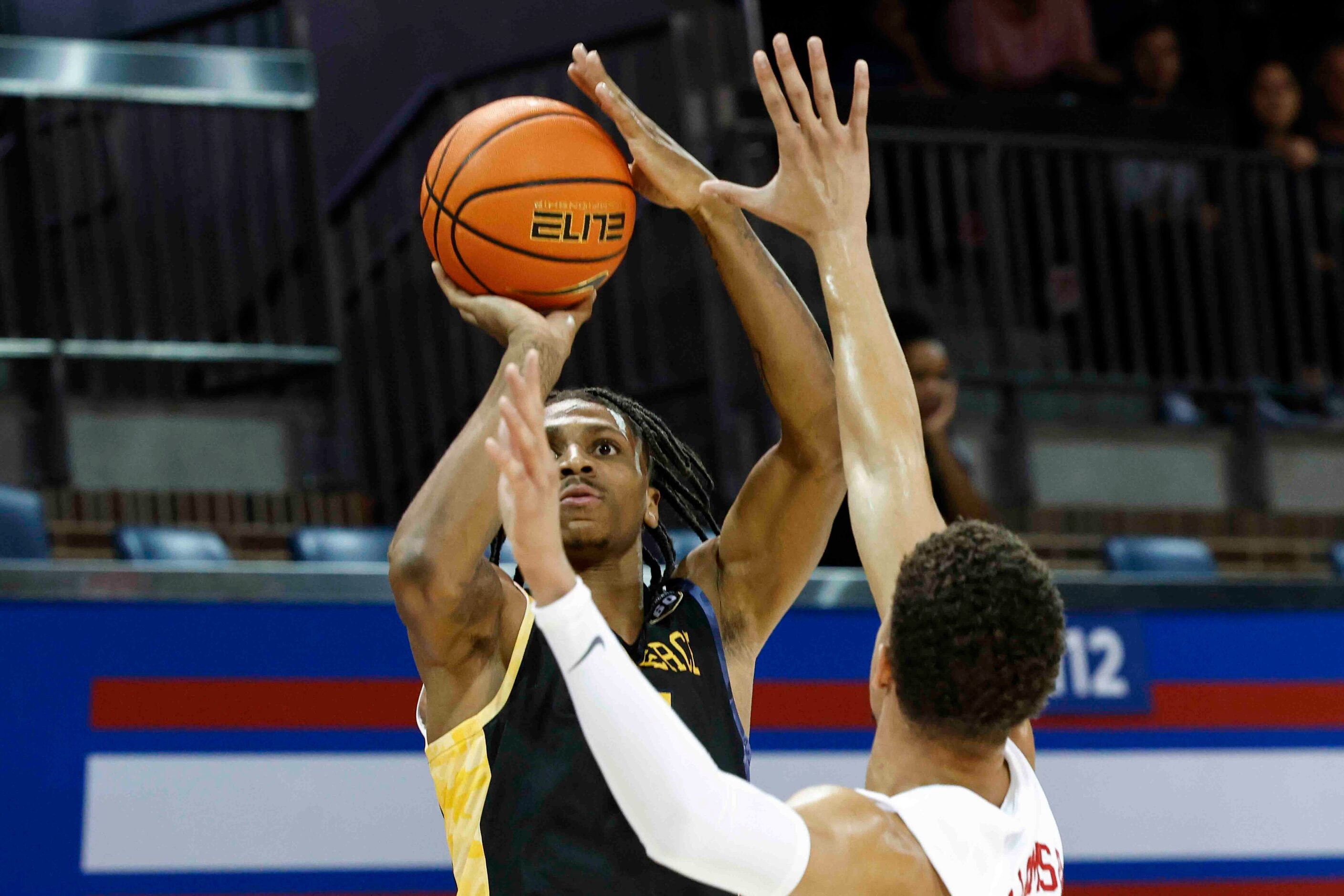 Texas A&M-Comm’s Demarcus Demonia (4), back, shoots a three-pointer past Southern Methodist...