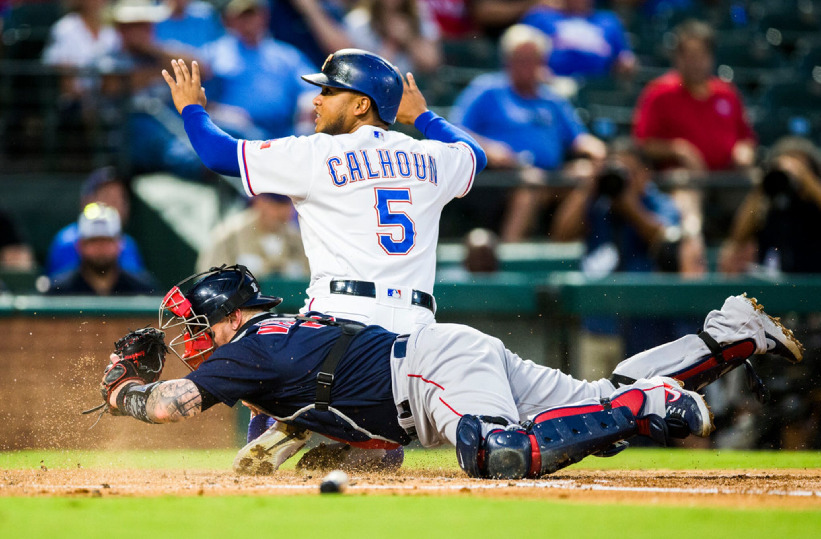 Texas Rangers designated hitter Willie Calhoun (5) looks for a call as he slides in to home...