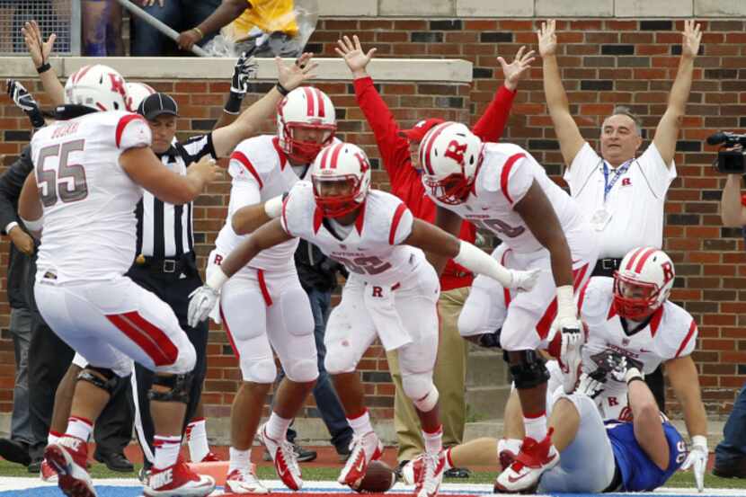 Rutgers running back Justin Goodwin, center, celebrates his game winning touchdown with...