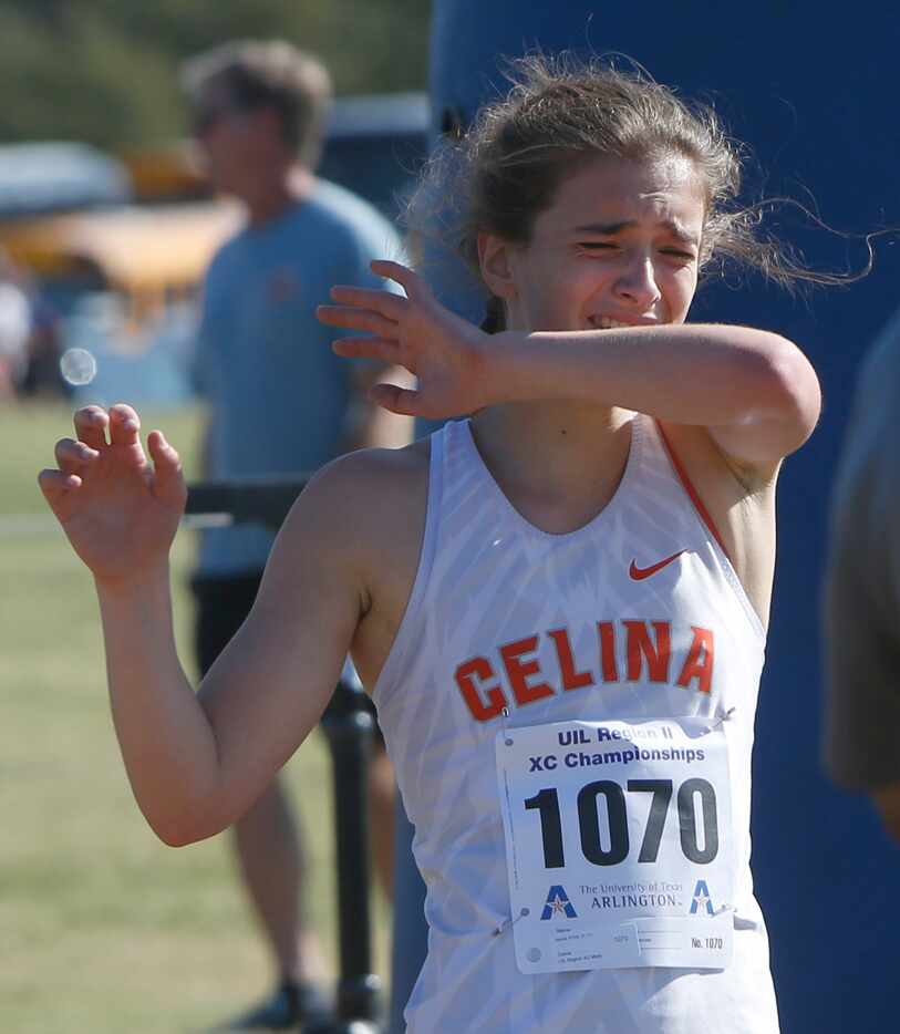 Celina's Alexis Frick reacts after her 3rd place finish with a time of 11:25.38 in the girls...