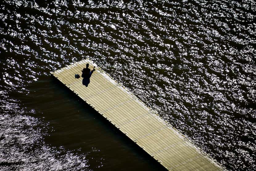 A man found solitude on a boat dock at White Rock Lake in Dallas on the first full day of...