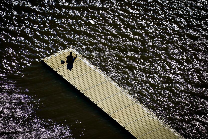 A man found solitude on a boat dock at White Rock Lake in Dallas on the first full day of...