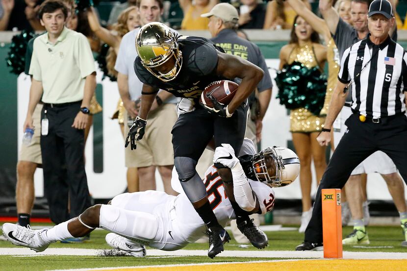 Baylor wide receiver Ishmael Zamora (8) powers past Oklahoma State safety Derrick Moncrief...