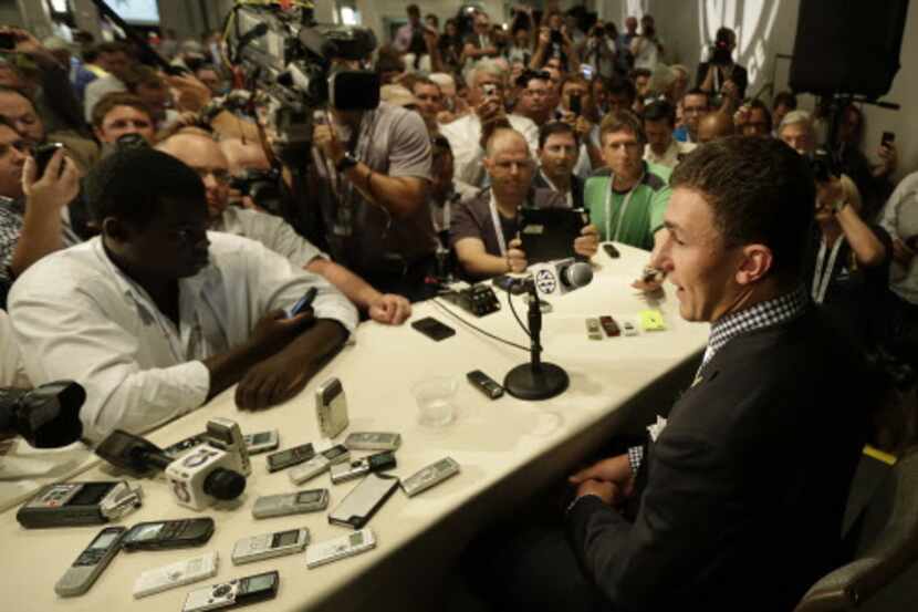 Johnny Manziel talks with reporters during the Southeastern Conference football Media Days...