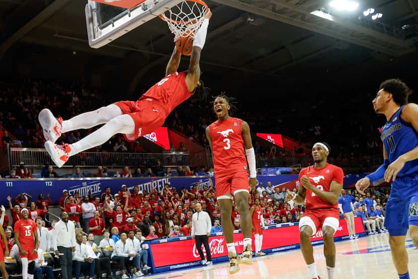 SMU guard Chuck Harris (3) reacts as guard B.J. Edwards (0) dunks the ball during the second...