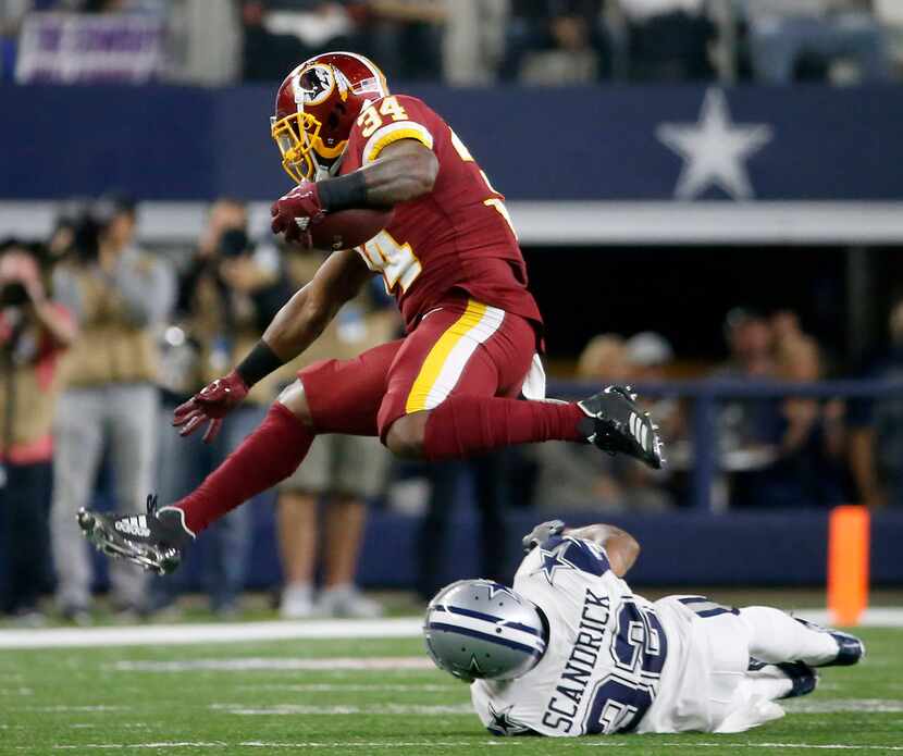 Washington Redskins running back Byron Marshall (34) hurdles Dallas Cowboys cornerback...