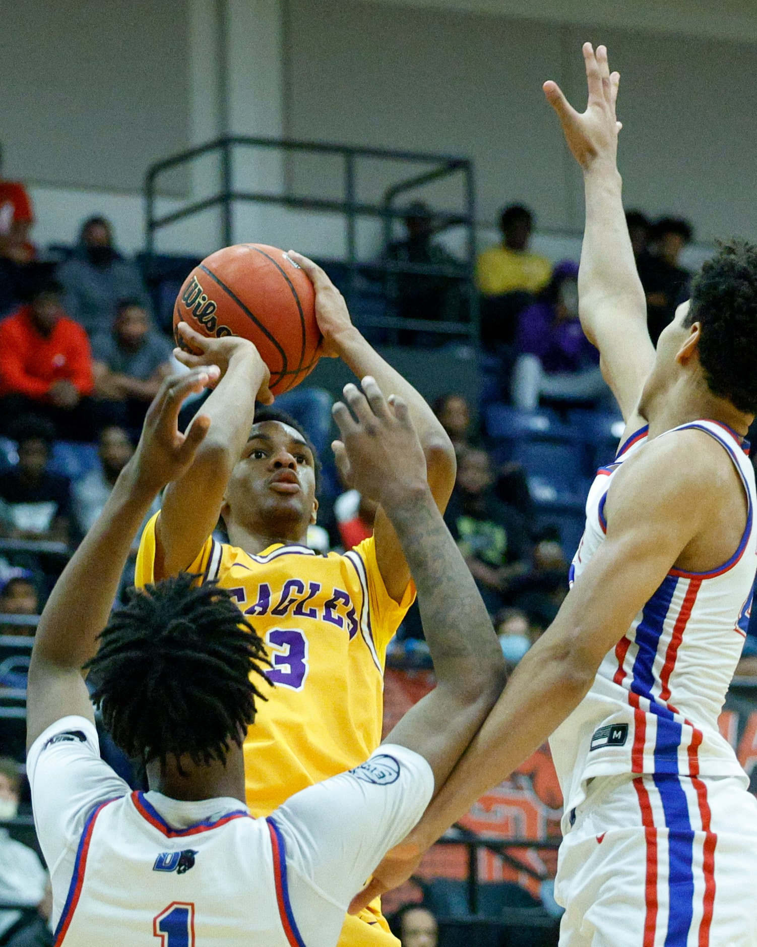 Richardson guard Rylan Griffen (3) shoots over Duncanville forward Ron Holland (1) and...