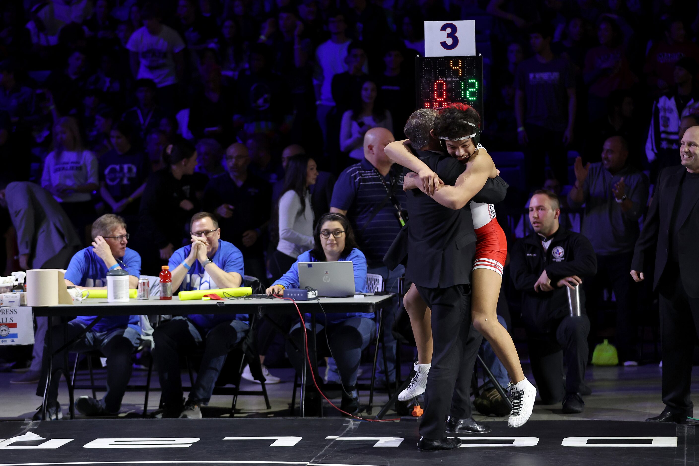 Nicholas Zamora of Arlington Martin celebrates with his coach after defeating Javin...