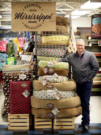 Shawn McGhee, president of Memphis-based Hollywood Feed, is photographed with pet beds made...