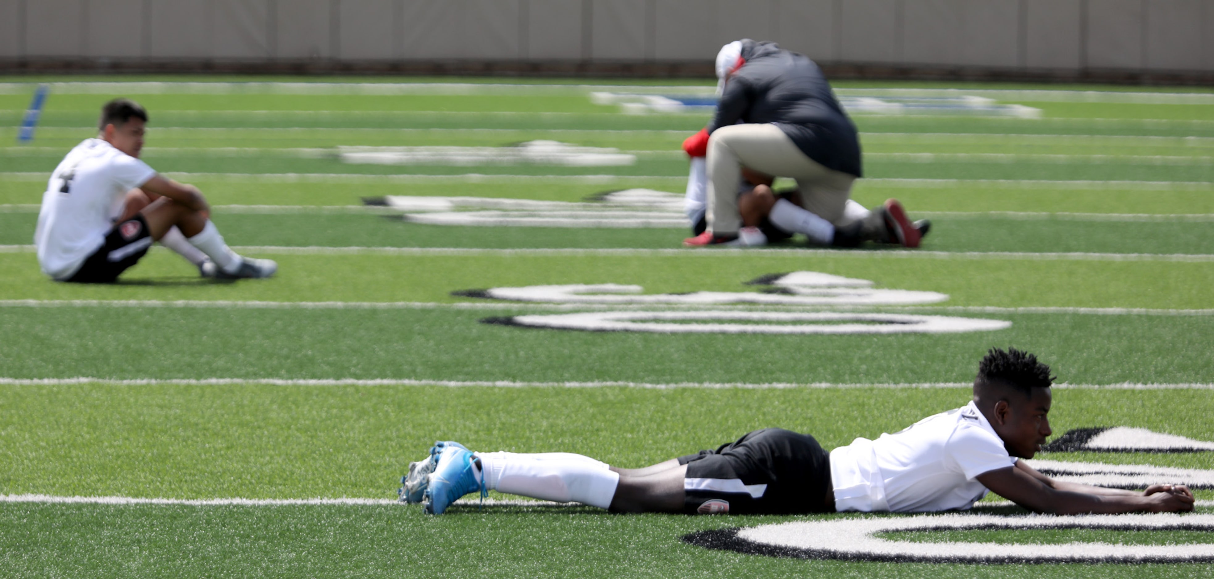 Fort Worth Diamond Hill-Jarvis' Enock Dusabe (front) and teammates react after their UIL 4A...