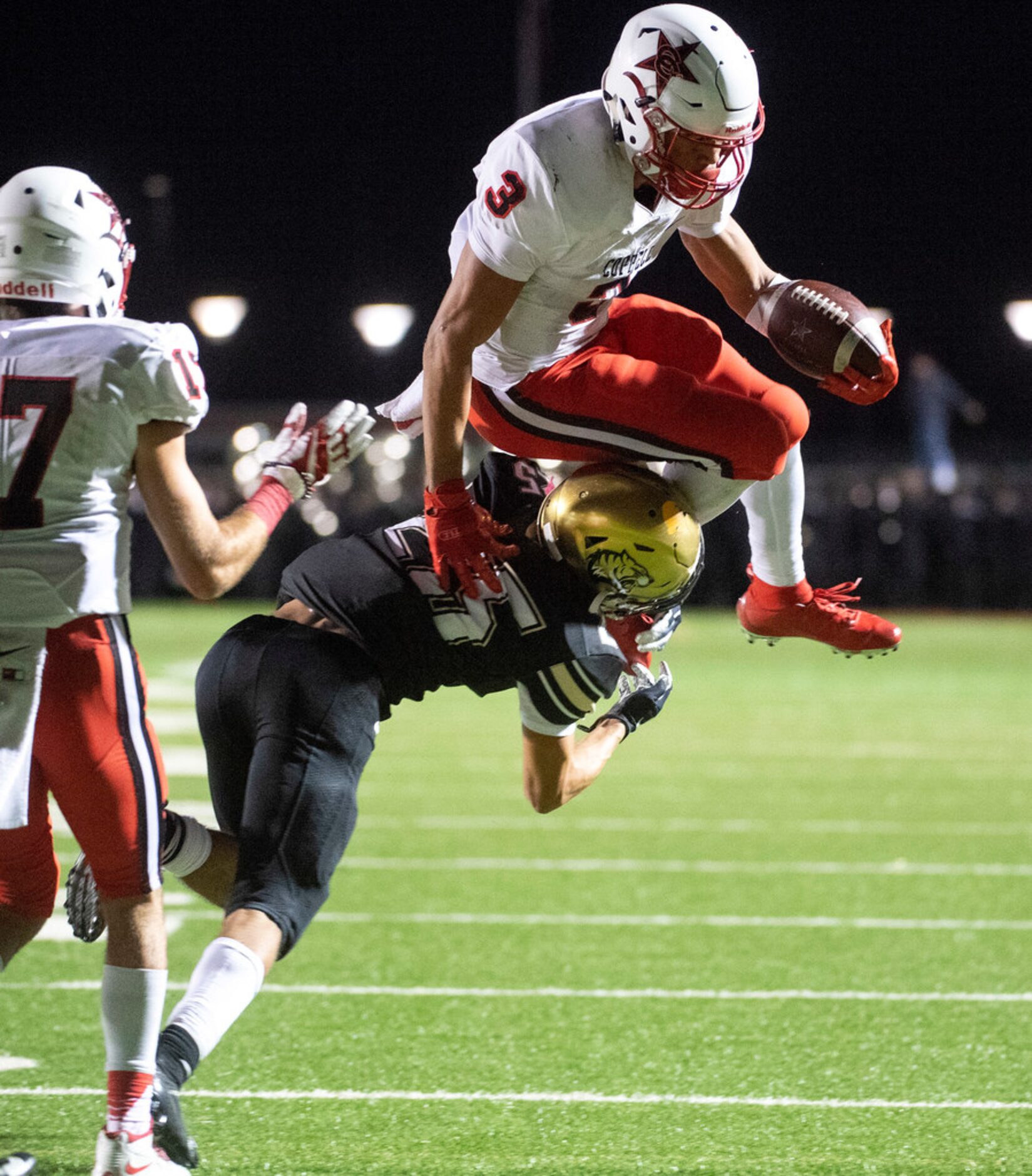 Coppell senior wide receiver Jonathan McGill (3) tries to leap over Irving senior defensive...