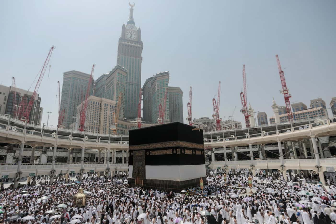 Muslim pilgrims circle the Kaaba, the cubic building at the Grand Mosque in the Muslim holy...