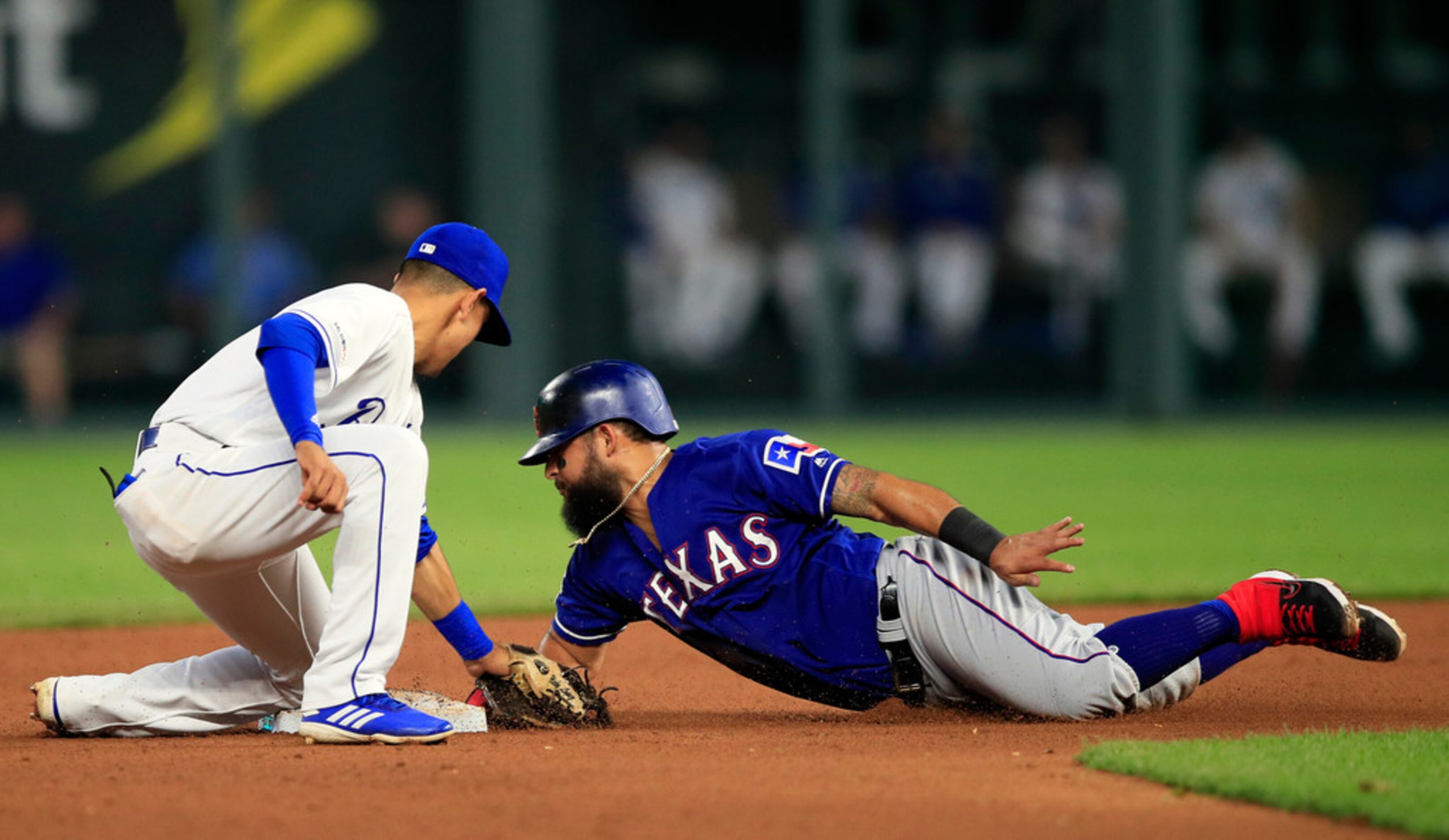 Texas Rangers' Rougned Odor, right, is tagged out by Kansas City Royals second baseman Nicky...